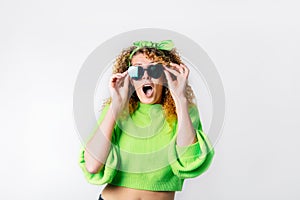 Bright emotional surprised, shocked woman in heart-shaped sunglasses with open mouth isolated on white background. Wow
