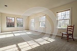 Bright empty room with carpet and windows