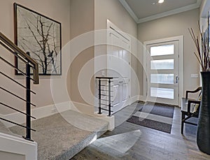 Bright entryway with creamy walls and hardwood floor