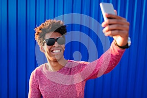 Bright ethnic man taking selfie