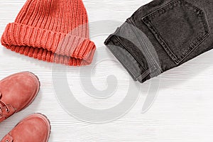 Bright fashion clothes trend colored. Knitted cap pink colored, comfort leather shoes and Black jeans.