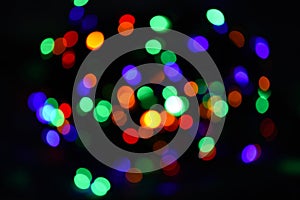 Bright and festive atmosphere of coming holiday. Abstract colorful bokeh background. Christmas decorations concept