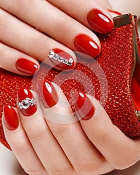 Bright festive red manicure on female hands. Nails design