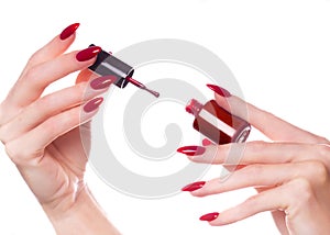 Bright festive red manicure on female hands. Nails design