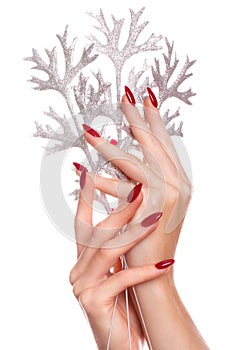 Bright festive red manicure on female hands. Nails design