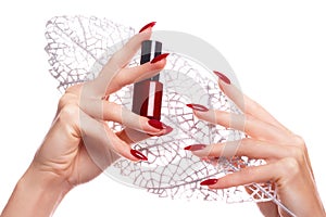 Bright festive red manicure on female hands. Nails design