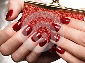 Bright festive red manicure on female hands. Nails design photo