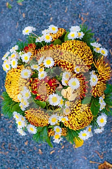 Bright floral decoration on grave during All Saints Day in the cemetery