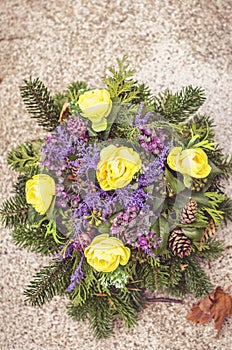 Bright floral decoration on grave during All Saints Day in the cemetery