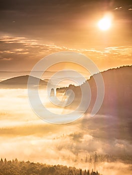 Bright fog and orange dawn over the valley bordered by the Blossstock massif