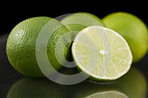 Bright fresh green limes on dark background