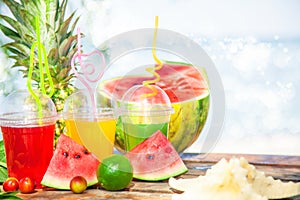 Bright Fresh healthy juices, fruit, pineapple, watermelon on the background of the sea. Summer, rest, healthy lifestyle