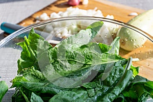 Bright fresh leaves of sorrel in a glass bowl. Rustic style.