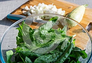 Bright fresh leaves of sorrel in a glass bowl. Rustic style.