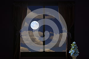 Bright full moon in cloudy sky, moonlight drop in blue flower vase in room