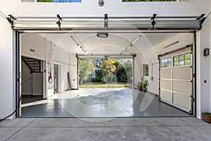 Bright garage space with dual overhead doors open
