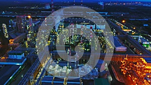 Bright gas and oil refinery plant at night aerial view