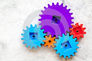 Bright gears for great technology of team work and correct mechanism on stone background top view copyspace