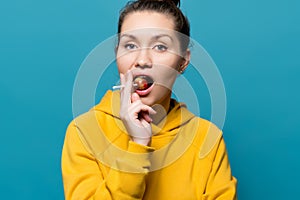 Bright girl holds lollipop in her mouth