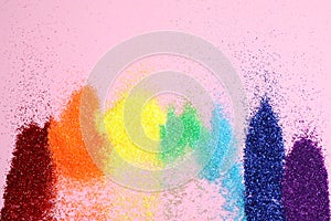 Bright glitters on pink background. Rainbow colors