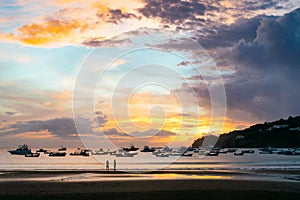 Bright glowing sunset sky over the water with boats in San Juan del Sur, Nicaragua