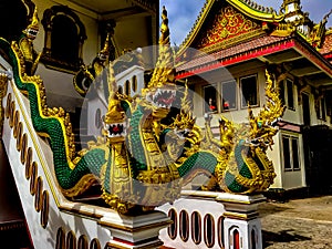 A bright gold and green carving of the multi-headed serpant god