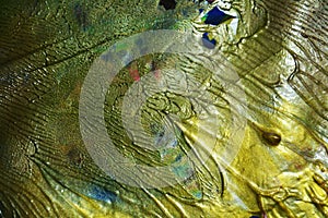 Bright gold paint abstraction background of fluid brush strokes paint. Watercolor paint abstract background.
