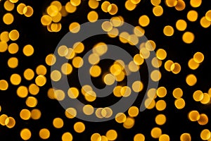 Bright Golden bokeh lights garland background. New year and Christmas. Abstract holiday background