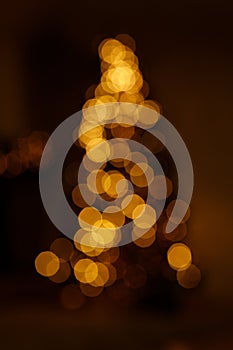 Bright golden bokeh lights in new year tree shape like overlay for your christmas design
