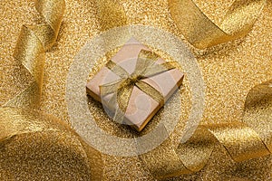 Bright golden New Year card, gift in craft packaging and ribbon for decoration