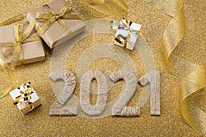 Bright golden new year card with gifts and lettering 2021, christmas tinsel