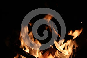 Bright golden orange flames against black background with copy space