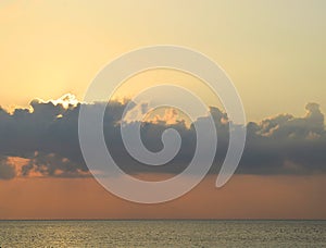 Bright Golden Sunrays through Clouds in Sky, Blue Sea Water and Horizon - Natural Background