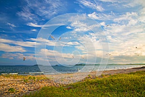 Bright golden sunset on the beach, the waves on the sand, shells.