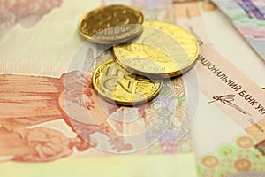 Bright golden ukrainian coins with banknots