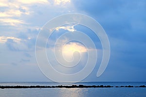 Bright Golden White Sunlight coming through Clouds and Falling over Infinite Sea Water at Horizon - Abstract Natural Background