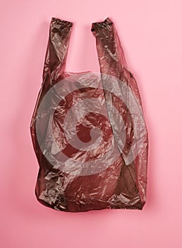 Bright gray plastic bag on red background.