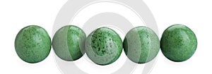 Bright green chewy gumballs isolated on white