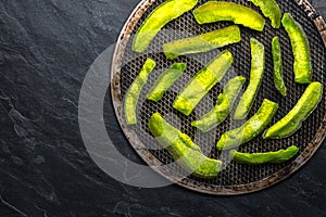 Bright green pieces of pomelo on the grill and on the blue stone free space