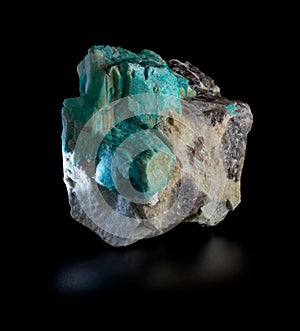 Bright green plagioclase amazonite mineral crystals and morion smoky quartz blotches in rock mineral rock isolated on