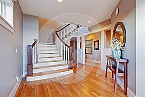 Bright hallway with wooden staircase photo