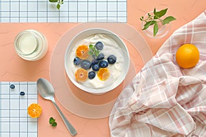 Bright, Healthy Breakfast Setup with Yogurt and Fresh Fruits on a Modern Kitchen Table. Perfect for a Food Blog or