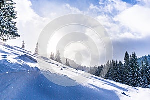 Bright high alpine winter scenery, with fresh snow and mist, in the Alps