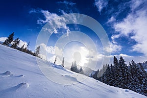 Bright high alpine winter scenery, with fresh snow and mist, in the Alps