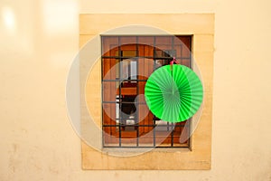 bright house with wooden windows and a green lantern