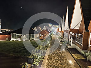 Bright houses during the midnight in the middle of farm in java