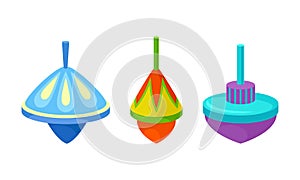 Bright Humming Top or Spinning Top as Squat Toy with Sharp Point at the Bottom Vector Set