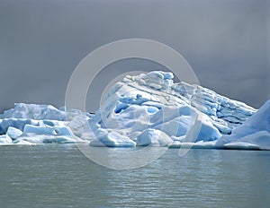 A bright iceberg with dark clouds