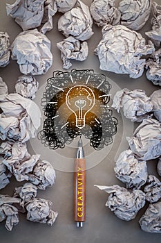 Bright idea concept with crumpled paper and bulb drawing