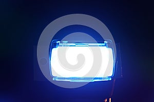 Bright illuminated flashing blue light on a dark background